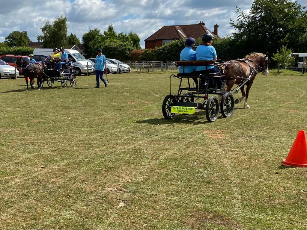 Two turnouts of horse and carriage being driven at the same time
